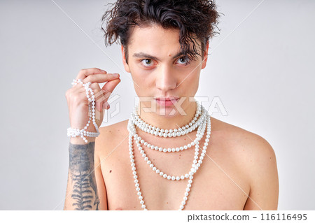 Slim shirtless brunette male model with necklace posing at camera isolated on white 116116495