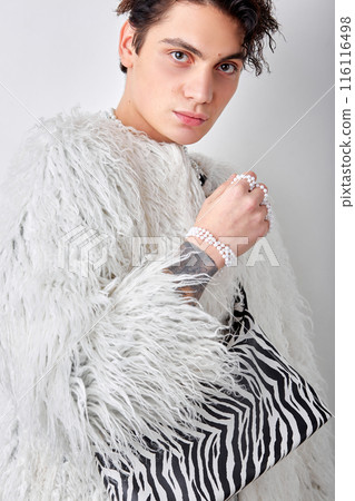 Male model in fashionable modern jacket posing at camera, alone, indoor shot 116116498