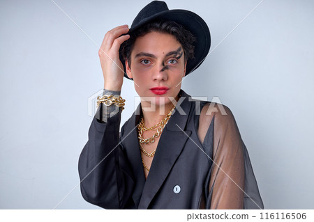 Portrait of emotive gender 20s transgender gay man wearing necklace, isolated on white 116116506