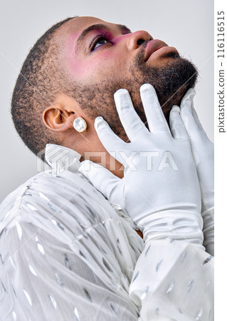 Closeup portrait of american man with make-up touching face head, in white gloves 116116515