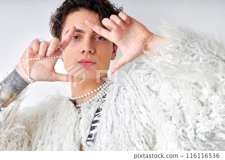 young brunette hispanic gay man with natural make up looking at camera isolated young brunette hispanic gay man with natural make up looking at camera isolated 116116536