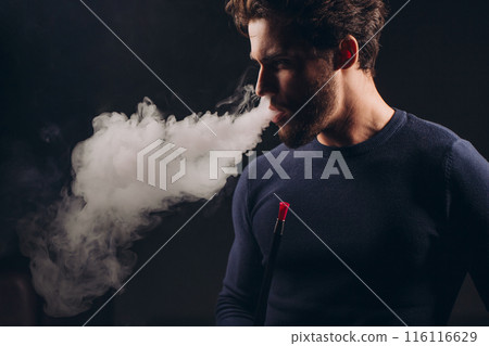 angry frustrated man trying tocalm down while smoking the hookah angry frustrated man trying tocalm down while smoking the hookah 116116629