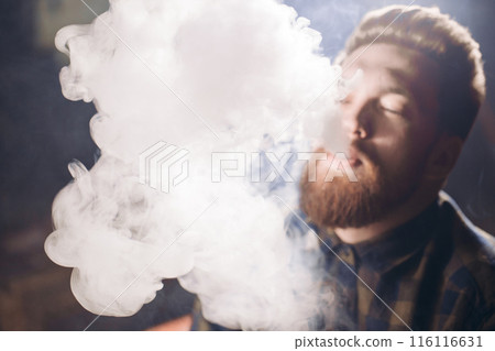 smoke of tobacco. young bearded man enjoying drugs smoke of tobacco. young bearded man enjoying drugs 116116631
