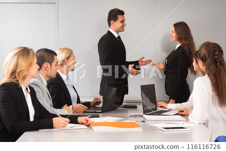 Meeting of clerks at large table 116116726