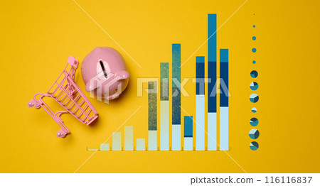 Ceramic piggy bank and graph with growing indicators on a yellow background Ceramic piggy bank and graph with growing indicators on a yellow background 116116837