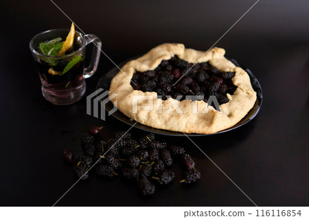 A galette pie with mulberry and cold homemade mojito, soda with the mulberry A galette pie with mulberry and cold homemade mojito, soda with the mulberry 116116854