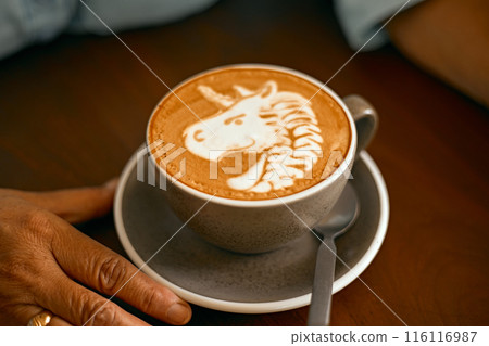 a cup of hot latte art coffee on wooden table a cup of hot latte art coffee on wooden table 116116987
