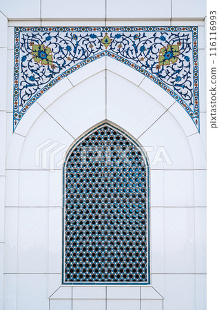 ceramic tile with a traditional Uzbek ornament with a oriental pattern. Window of white mosque Minor in Uzbekistan 116116993