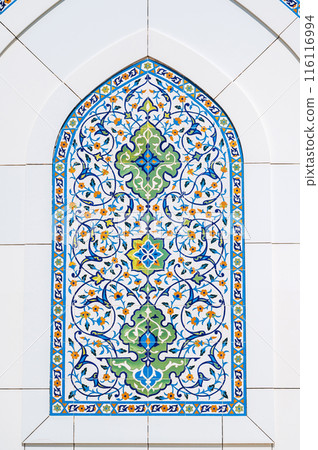 Uzbek ceramic tile decor with oriental patterns and ornaments on marble wall of white Minor Mosque in Tashkent in Uzbekistan 116116994