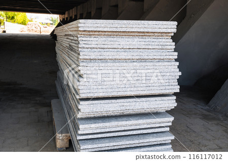stack of white marble slabs on construction site for decoration of facade of building stack of white marble slabs on construction site for decoration of facade of building 116117012