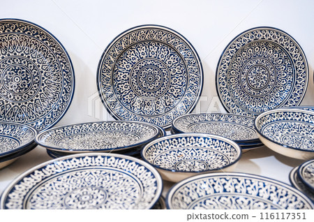 Uzbek handmade ceramic plate with hand-painted Islamic pattern in pottery workshop in Uzbekistan Uzbek handmade ceramic plate with hand-painted Islamic pattern in pottery workshop in Uzbekistan 116117351