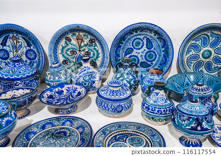 Uzbek handmade ceramic plates and tableware with hand-painted traditional Asian blue patterns at bazaar Uzbek handmade ceramic plates and tableware with hand-painted traditional Asian blue patterns at bazaar 116117554