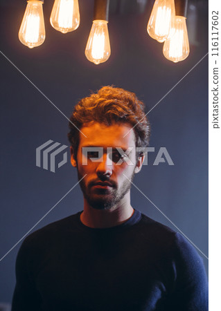 attractive Caucasian guy with serious look posing to the camera attractive Caucasian guy with serious look posing to the camera 116117602