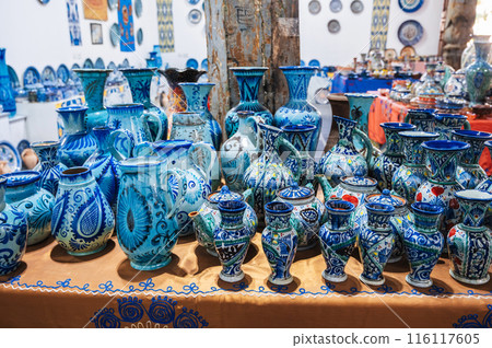 traditional Asian Uzbek ceramic vases, jugs and teapots hand-painted on oriental market in Uzbekistan 116117605