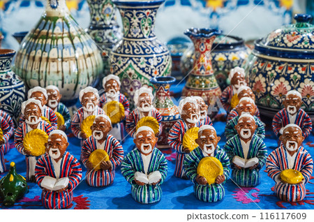 Colorful traditional Asian Uzbek figurines and ceramic vases hand-painted in oriental shop in Uzbekistan 116117609