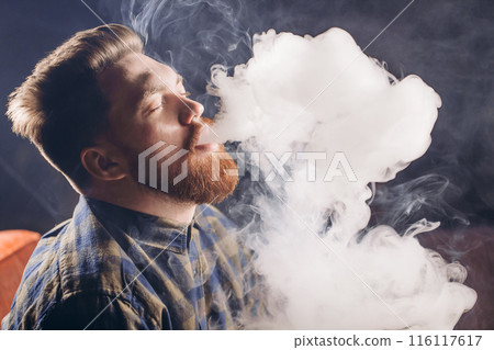 young relaxed man with red beard is inebriated 116117617