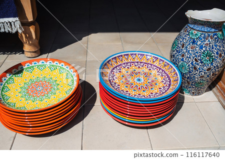 traditional colorful Uzbek plates and ceramic vase hand-painted at street oriental market in Uzbekistan 116117640