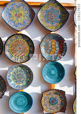 traditional Asian Uzbek ceramic plates hand-painted at oriental street bazaar in Uzbekistan in Tashkent traditional Asian Uzbek ceramic plates hand-painted at oriental street bazaar in Uzbekistan in Tashkent 116117653