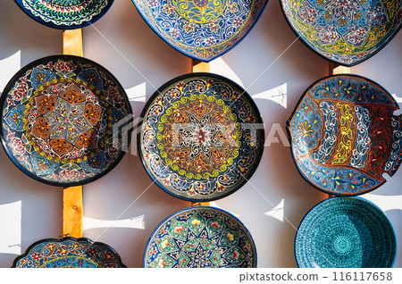 traditional Asian Arab Uzbek ceramic plates hand-painted at oriental street bazaar in Uzbekistan in Tashkent traditional Asian Arab Uzbek ceramic plates hand-painted at oriental street bazaar in Uzbekistan in Tashkent 116117658