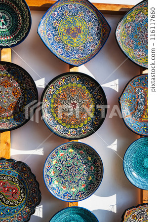 Uzbek ceramic plates hand-painted at oriental street bazaar in Uzbekistan in Tashkent Uzbek ceramic plates hand-painted at oriental street bazaar in Uzbekistan in Tashkent 116117660