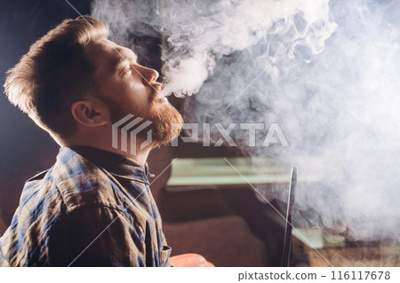 magicical smoking. young man relaxing with hookah magicical smoking. young man relaxing with hookah 116117678