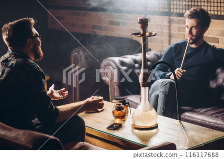 two cherful men having a conversation in the informal area 116117688