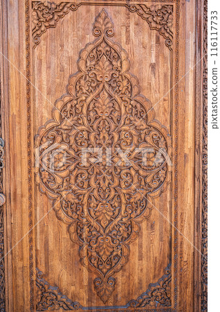 tajik kandakori patterns arabesque ornament on an ancient wooden carved door in Tajikistan close up tajik kandakori patterns arabesque ornament on an ancient wooden carved door in Tajikistan close up 116117733