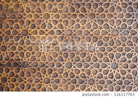 Uzbek Islamic patterns ornament with stars on a modern wooden carved door in Uzbekistan close up 116117763