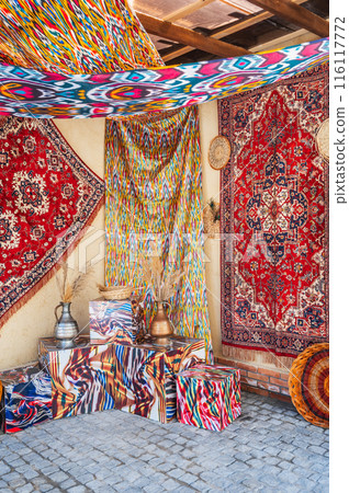 Beautiful expensive vintage traditional red handmade carpets at the oriental bazaar in Uzbekistan Beautiful expensive vintage traditional red handmade carpets at the oriental bazaar in Uzbekistan 116117772