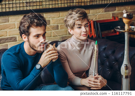gorgeous young couple sitting at the cafe gorgeous young couple sitting at the cafe 116117791