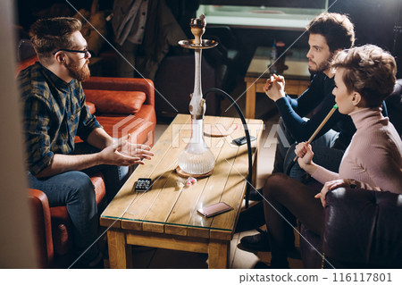 young ambitious business people are discussiong something at the restaurant young ambitious business people are discussiong something at the restaurant 116117801