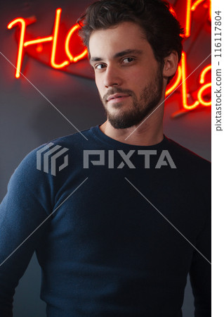 handsome cheerful man posing to the camera at night club handsome cheerful man posing to the camera at night club 116117804