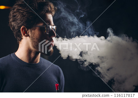 young handsome man having fun with hookah young handsome man having fun with hookah 116117817