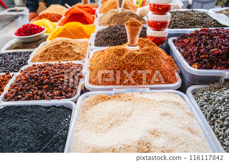 assortment of various oriental spices and seasonings on the counter at Asian bazaar assortment of various oriental spices and seasonings on the counter at Asian bazaar 116117842