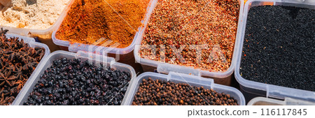 assortment of various oriental spices on counter at the Asian Uzbek bazaar in close-up assortment of various oriental spices on counter at the Asian Uzbek bazaar in close-up 116117845