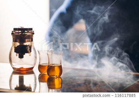 closeup photo glasses with tea are on a table. 116117885