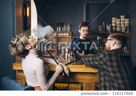 young fashion fair-haired girl enjoying the pleasant company at bar 116117889
