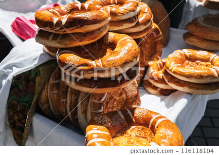 traditional Asian bread kazakh tandoor flatbread on counter at bazaar in Kazakhstan 116118104