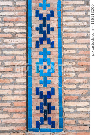 traditional Arabic Uzbek ceramic tile patterns on brick wall of ancient Islamic Kukeldash Madrasah in Tashkent in Uzbekistan 116118200