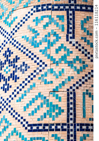 traditional Uzbek ceramic tile patterns on brick wall of the ancient Muslim Islamic Kukeldash Madrasah in Tashkent in Uzbekistan 116118214
