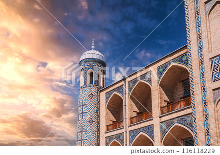 Brick walls decorated with ceramic tiles with arabic pattern of Kukeldash madrasah in Uzbekistan in Tashkent. Ancient old Islamic madrassa on background of the beautiful sky 116118229