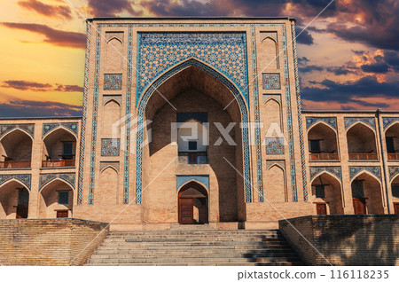 portal of ancient Uzbek Islamic Kukeldash madrasah in Tashkent in Uzbekistan. Old stone madrasa in Asia at sunset 116118235