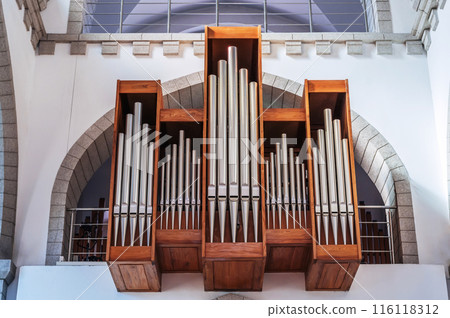 pipes of a church organ inside the interior of a Christian Catholic church. Cathedral of Sacred Heart of Jesus in Tashkent in Uzbekistan 116118312
