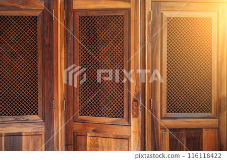 open wooden door with a lattice to the confessional for confession inside Catholic Cathedral 116118422