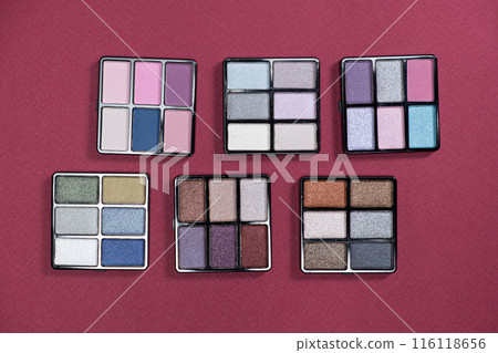 A set of multi-colored eyeshadow on a pink background. Eye makeup 116118656