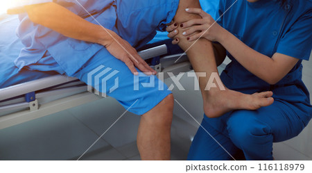 Physical therapists work with patients in close-up clinics. The concept of rehabilitation of physical health, the doctor gives advice to the patient. Ankle problems and muscle injuries Physical therapists work with patients in close-up clinics. The concept of rehabilitation of physical health, the doctor gives advice to the patient. Ankle problems and muscle injuries 116118979