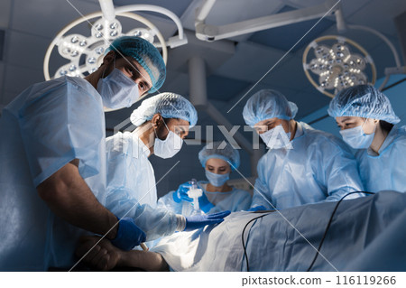 Surgeons perform a complex operation to save a human life at hospital Surgeons perform a complex operation to save a human life at hospital 116119266