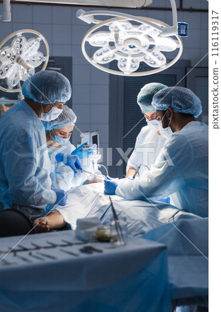 Surgeons perform a complex operation to save a human life at hospital Surgeons perform a complex operation to save a human life at hospital 116119317