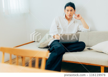 A man who works on a personal computer 116119978