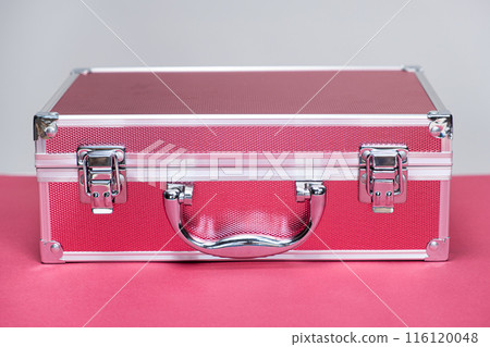 Small suitcase, box for cosmetics on a pink background 116120048